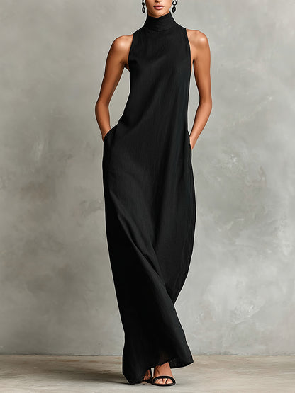 Vestido negro Caterina de cuerpo entero, con las manos en los bolsillos