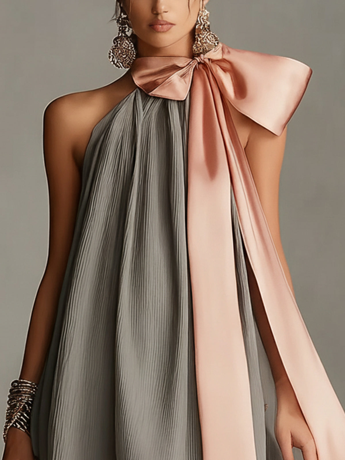 Vestido gris plisado con lazo rosa y ribete de encaje vista frontal